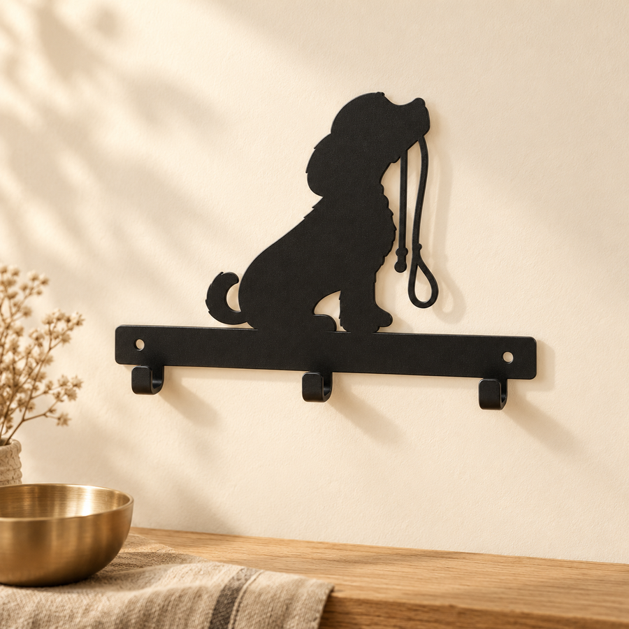Empty black three-hook wall rack with a seated dog silhouette mounted above a light wood console