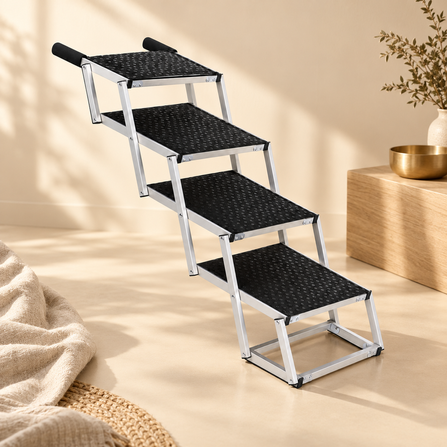 Open four-step dog stairs with black textured treads and silver framing in a neutral cream interior.
