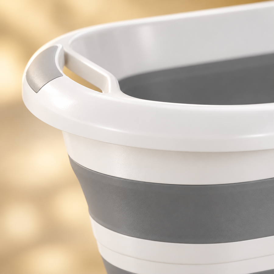 Close view of a molded grip opening in the white rim above the gray flexible wall of the pet bathtub.