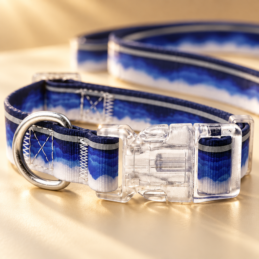 Close view of the clear buckle, metal ring and navy-and-white pattern on a flat dog collar