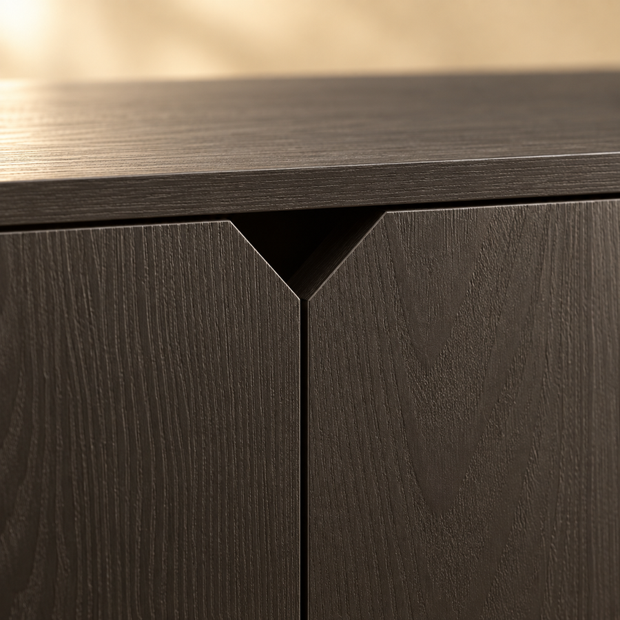Close-up of the V-shaped cutout handles on the black wood-grain doors of a litter box enclosure