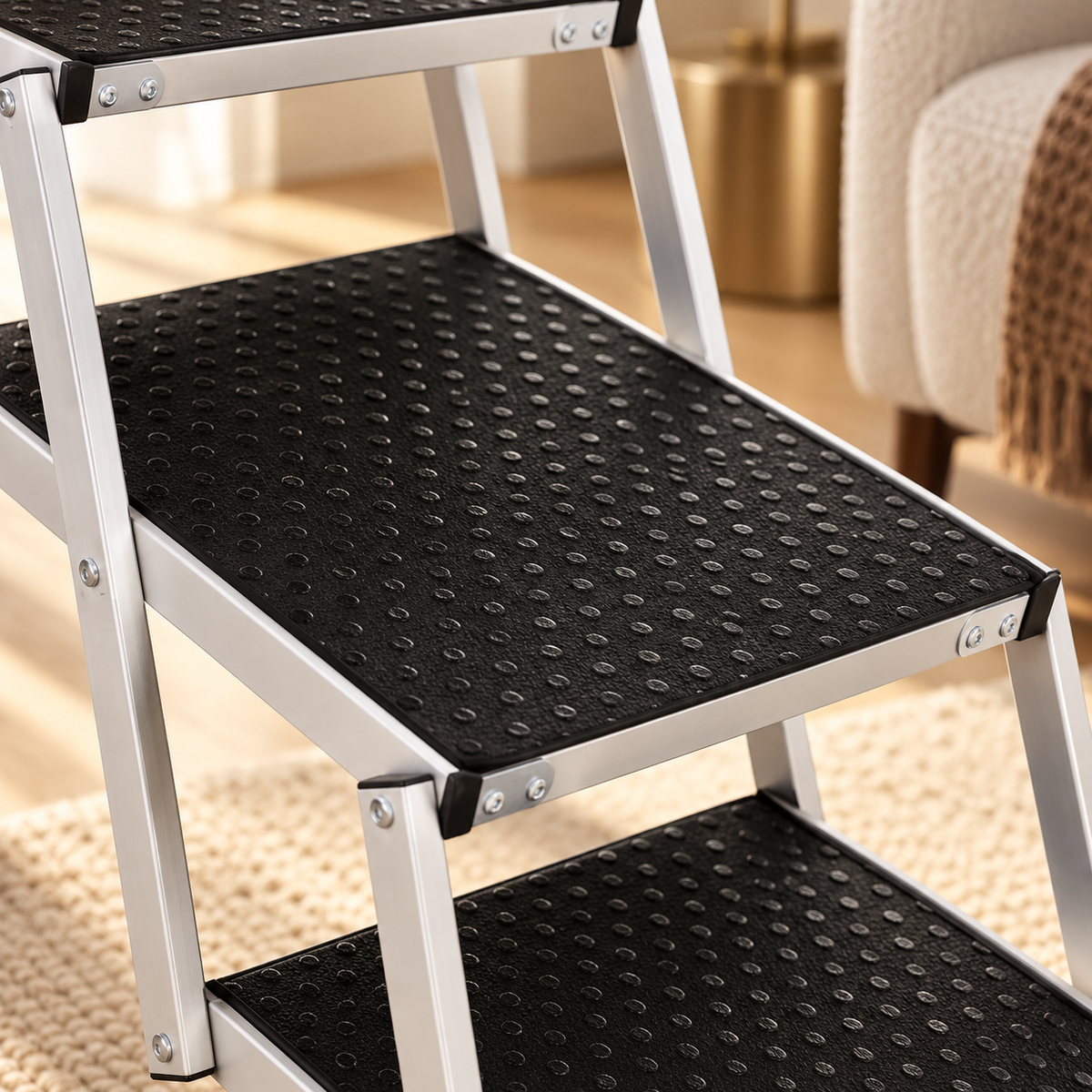 Close view of the dotted black tread surfaces and rectangular silver aluminum frame of the dog stairs.
