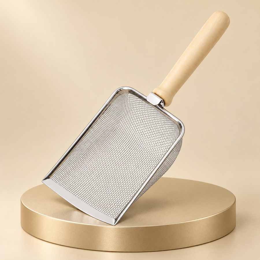Fine mesh stainless steel cat litter scoop with a light wood handle on a round champagne display pedestal