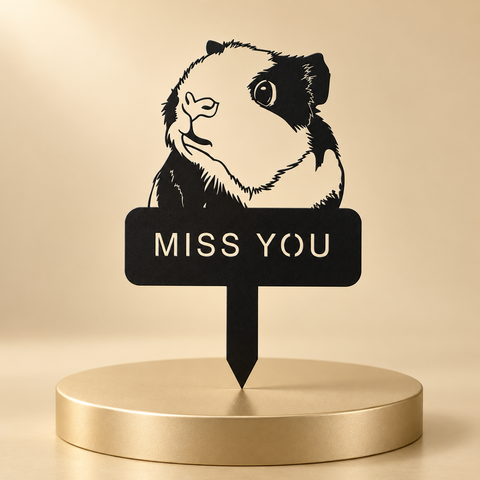 Black guinea pig memorial stake with a cutout MISS YOU inscription displayed on a champagne plinth