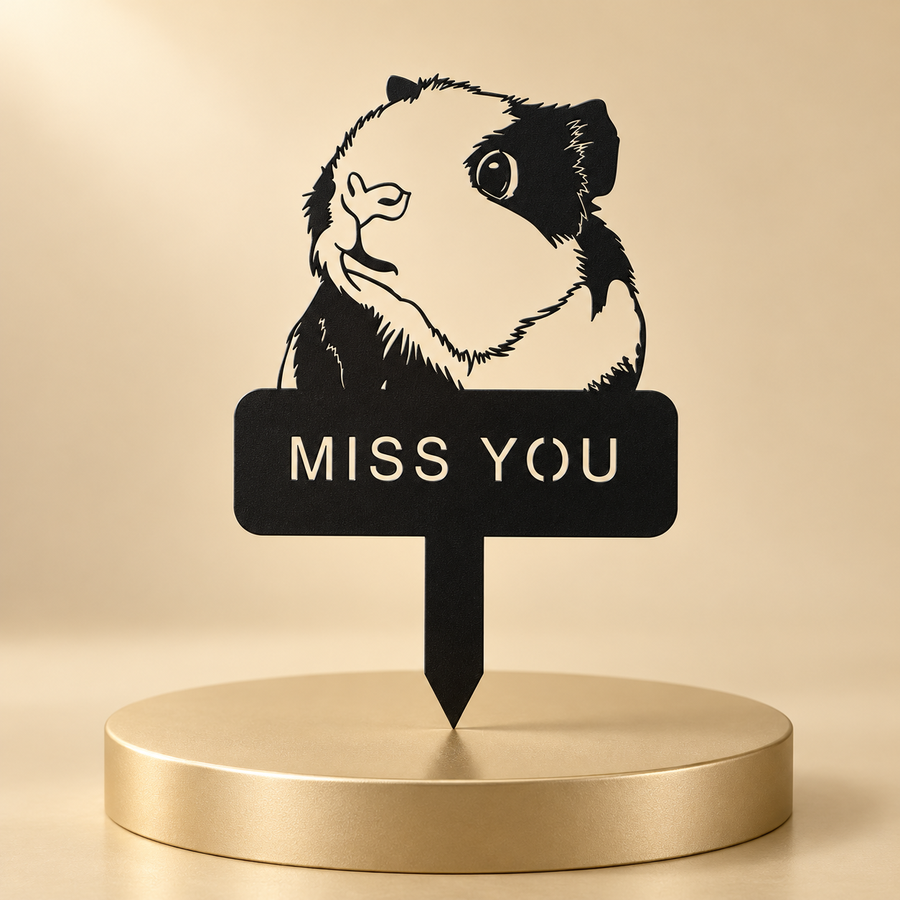 Black guinea pig memorial stake with a cutout MISS YOU inscription displayed on a champagne plinth