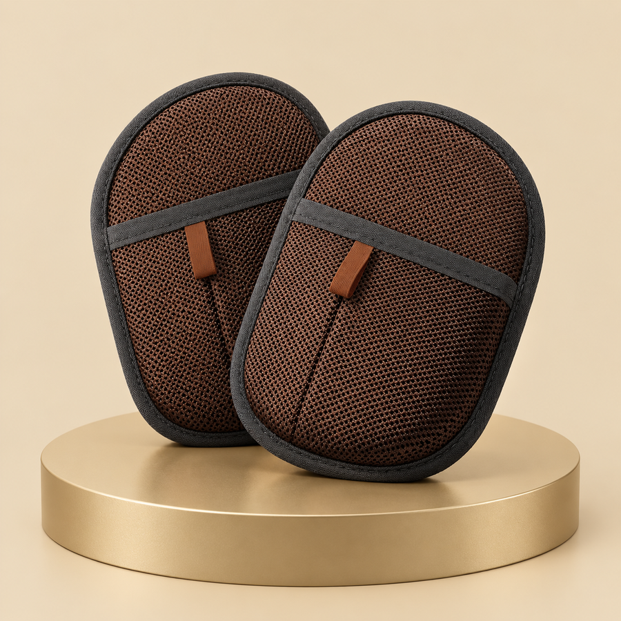 Pair of dark brown pet hair remover mitts with gray trim standing on a champagne plinth