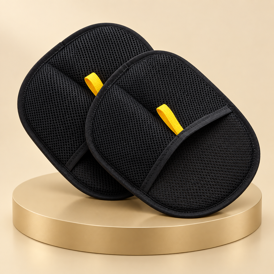 Two black pet hair remover mitts with yellow loops on a round champagne plinth