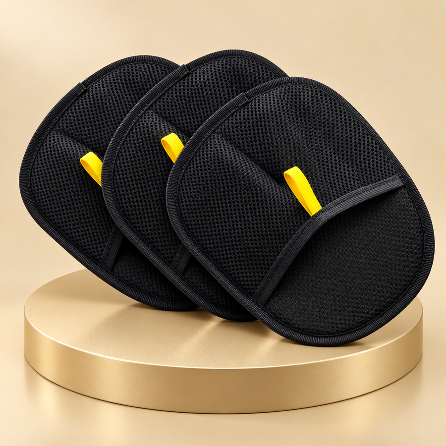 Set of three black pet hair mitts with yellow tabs, fanned out on a golden plinth